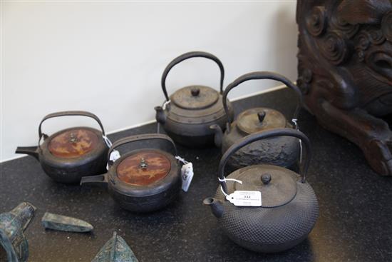 Five Japanese cast iron teapots, two with lacquer covers, 19th century, largest 19cm wide
